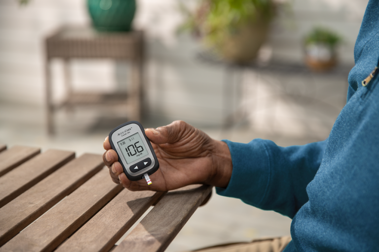 Man holding Accu-Chek® Guide Me meter